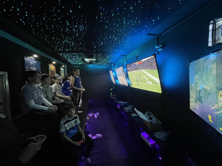 Full group of kids playing inside the climate-controlled gaming trailer