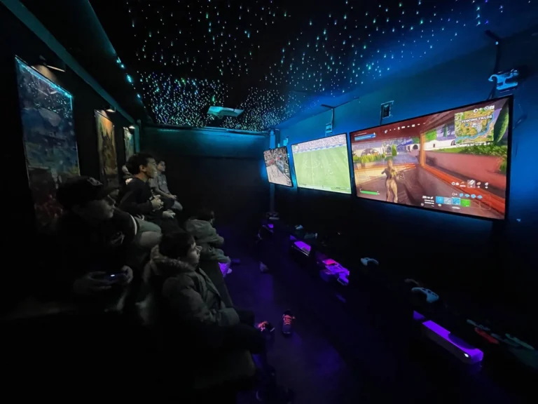 Kids gaming under the starry LED ceiling of the video game truck