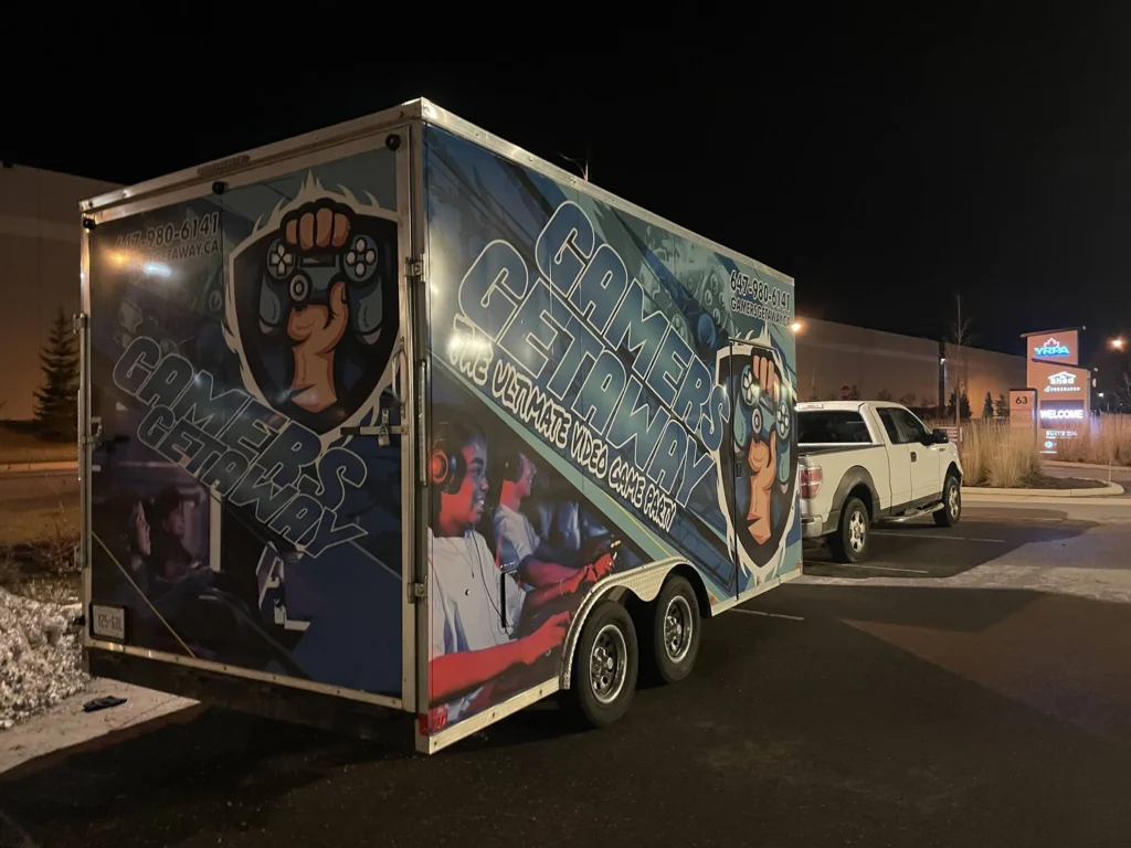 The Gamers Getaway trailer and pickup truck parked on a winter evening