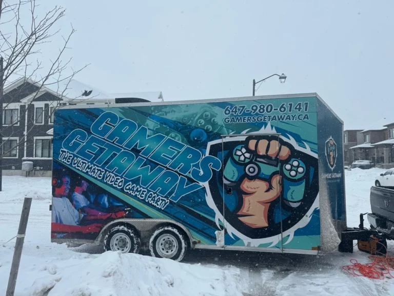 Gamers Getaway video game trailer set up on a snowy residential street