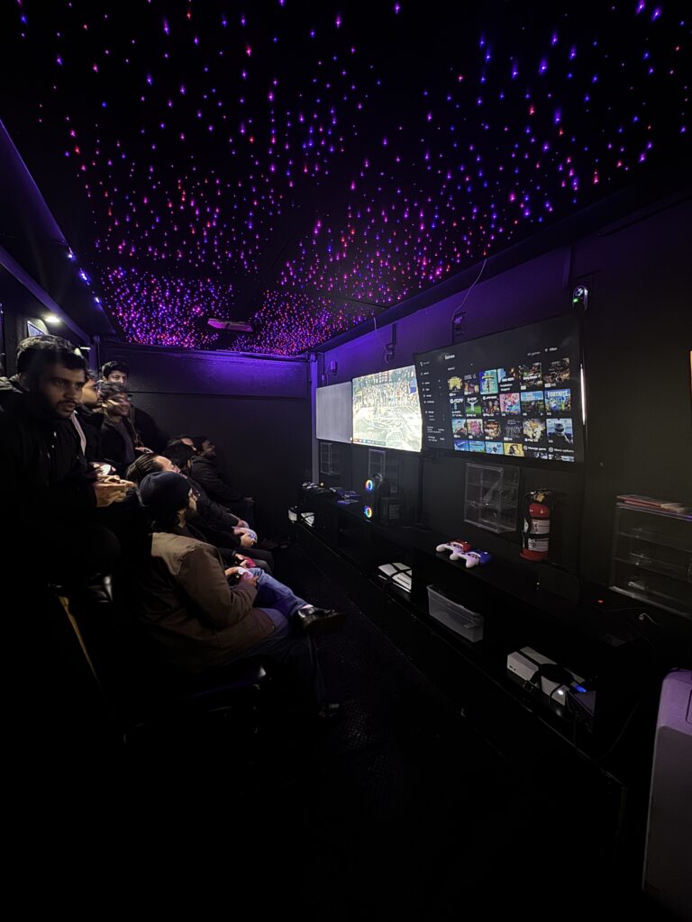 The starry ceiling and gaming screens inside the Gamers Getaway trailer during a January party