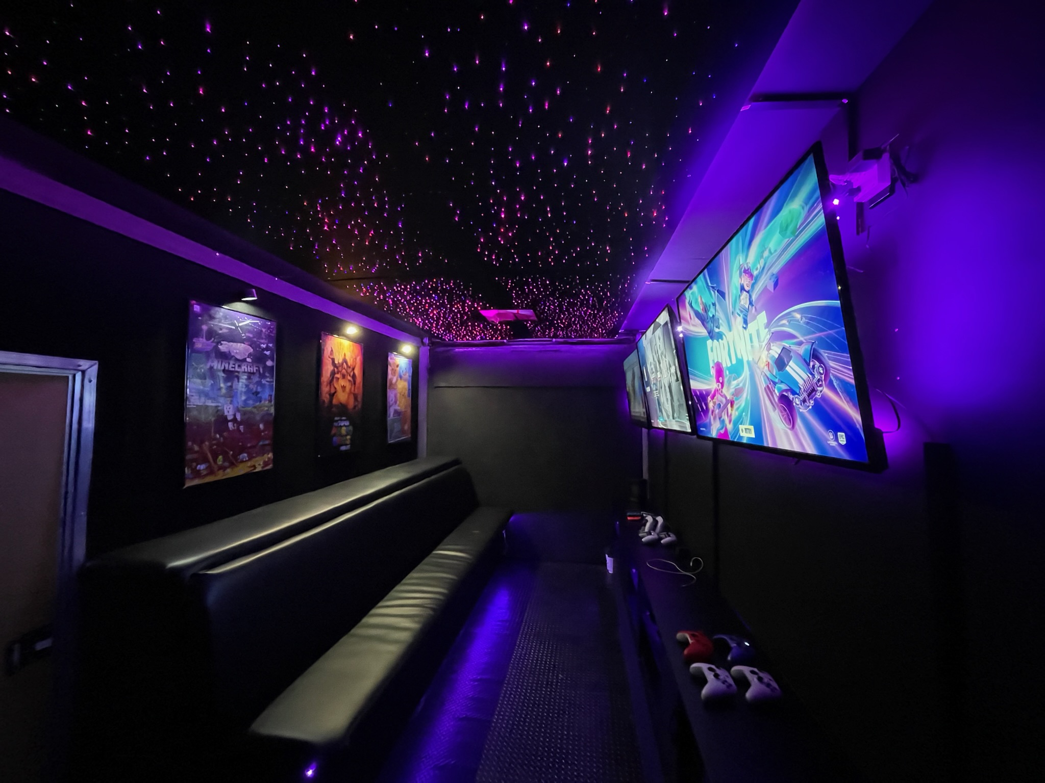 Inside the Gamers Getaway video game truck: wall-mounted screens, LED lighting and a starry ceiling